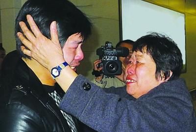 手摸22年未见的儿子，母亲热泪盈眶。陈哲 朱鼎兆 摄